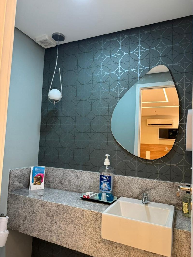 Triuno: lavabo com papel de parede geométrico